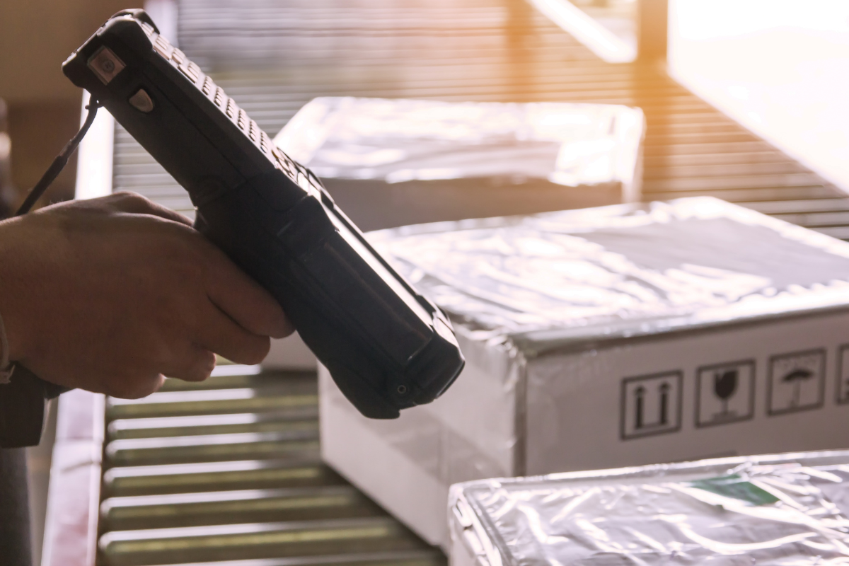 Handheld scanner in warehouse scanning boxes